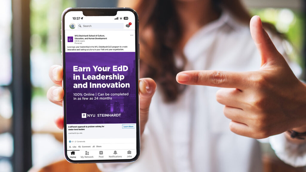 Woman pointing at her phone screen with an NYU EdD LinkedIn ad on the screen